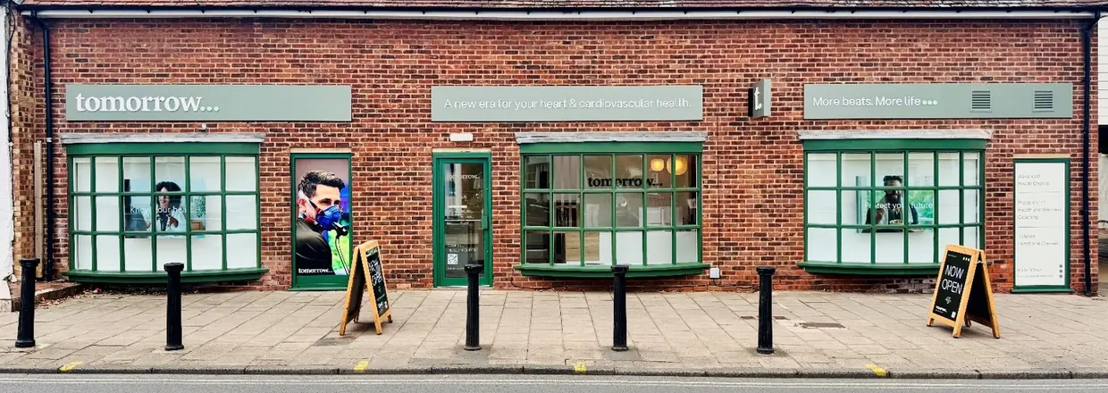 The Tomorrow clinic frontage on Knowle High Street, a brick shopfront with green windows and a Now open sign
