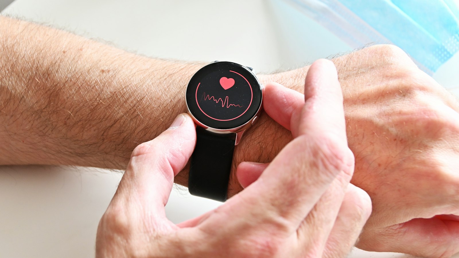 A person checking their heart rate on a smartwatch