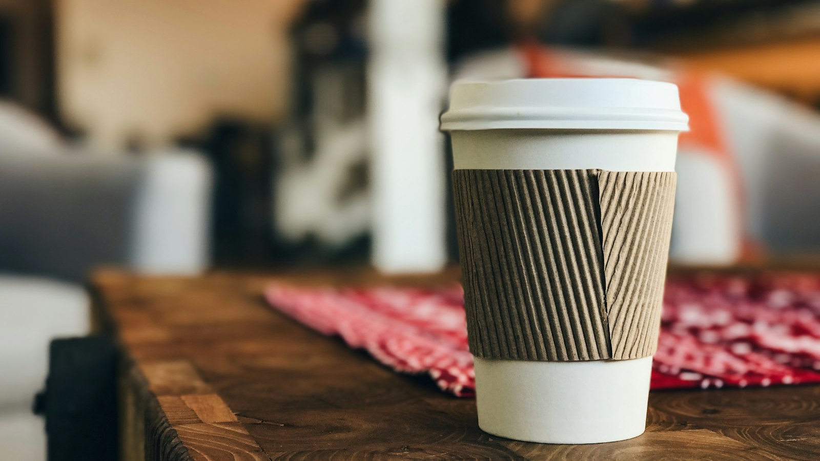 A takeaway coffee cup on a café table